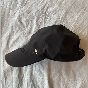 Lululemon black dry-fit hat with adjustable Velcro strap